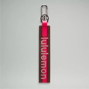 Lululemon Pink and Brown Never lost Word mark Keychain NWOT